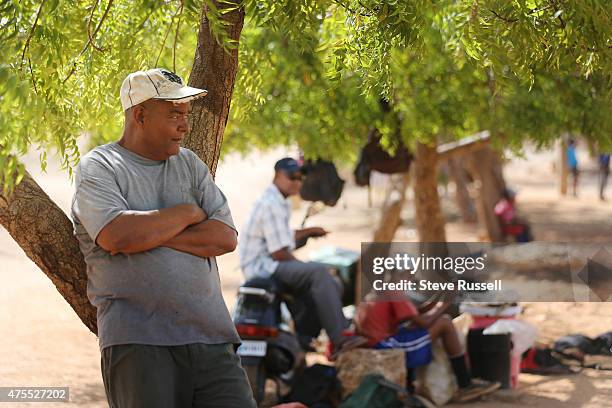 Miguel Castro Sr. Watches the next group of players on the field where his son played at the Academia de Beisbol Rafael Mejia S. Rafael Mejia...