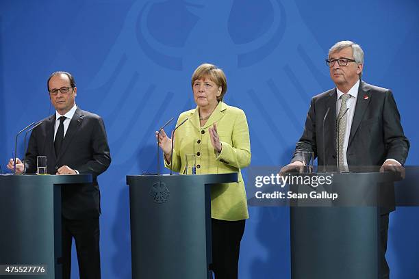 German Chancellor Angela Merkel, French President Francois Hollande and European Union Commission President Jean-Claude Juncker give statements to...