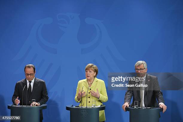 German Chancellor Angela Merkel, French President Francois Hollande and European Union Commission President Jean-Claude Juncker give statements to...