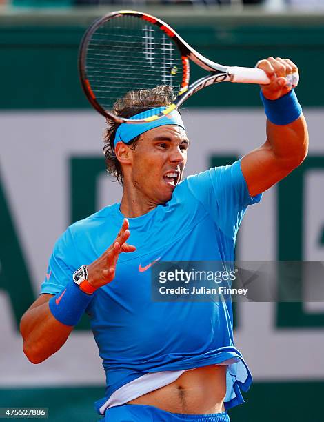 Rafael Nadal of Spain returns a shot in his Men's Singles match against Jack Sock of the United States on day nine of the 2015 French Open at Roland...