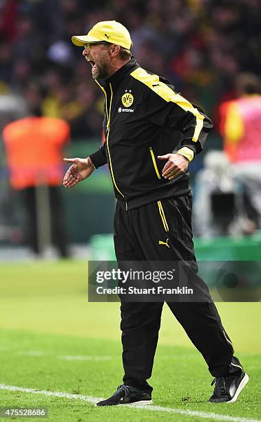 Juergen Klopp, head coach of Dortmund shouts and gestures during the DFB Cup Final between Borussia Dortmund and VfL Wolfsburg at Olympiastadion on...