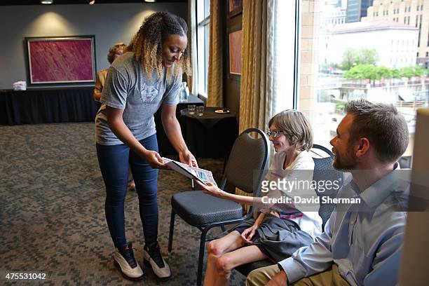 Monica Wright of the Minnesota Lynx visits the Science Museum of Minnesota with Wishes & More Kids and their families on May 29, 2015 in St. Paul,...