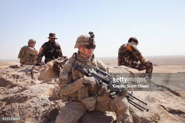 Richard Reilly of Chicago, Illinois and other soldiers with the U.S. Army's 4th squadron 2d Cavalry Regiment patrol with police from Afghanistan's...