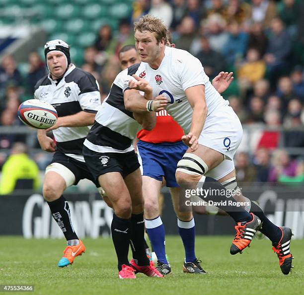 Joe Launchbury of England passes the ball during the Rugby Union International match between England and the Barbarians at Twickenham Stadium on May...