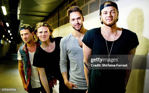 Andy Brown, Ryan Fletcher, Joel Peat and Adam Pitts of Lawson pose backstage after performing and signing copies of their album 'Roads' at HMV...