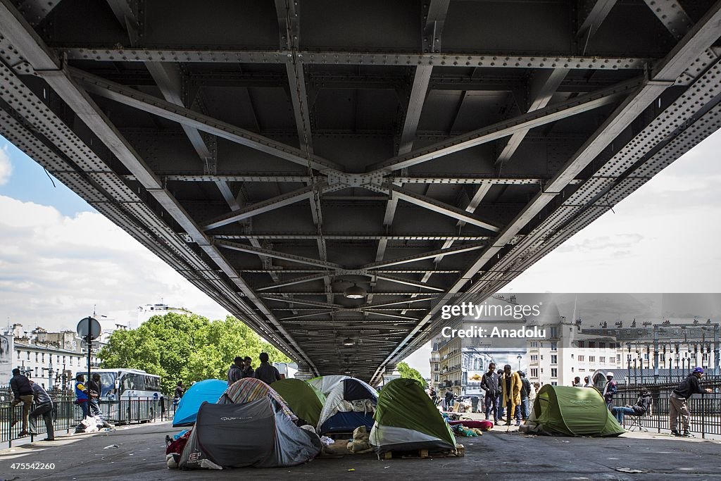 Migrants camp under the bridge in Paris