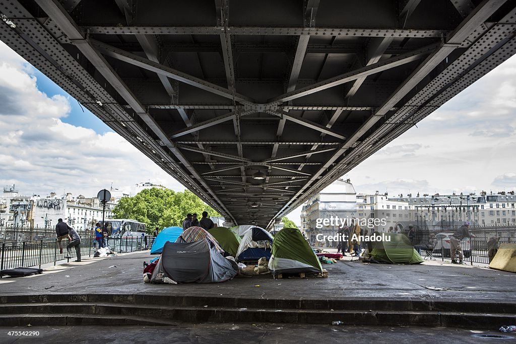 Migrants camp under the bridge in Paris