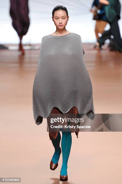 Model walks the runway during the Issey Miyake show as part of Paris Fashion Week Womenswear Fall/Winter 2014-2015 on February 28, 2014 in Paris,...