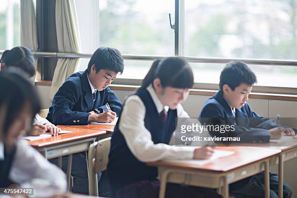 japanese students working in the classroom - japanese school uniform stock pictures, royalty-free photos & images