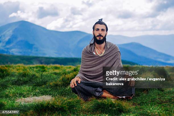 yogi meditating in mountains, ukraine - yogi stock-fotos und bilder