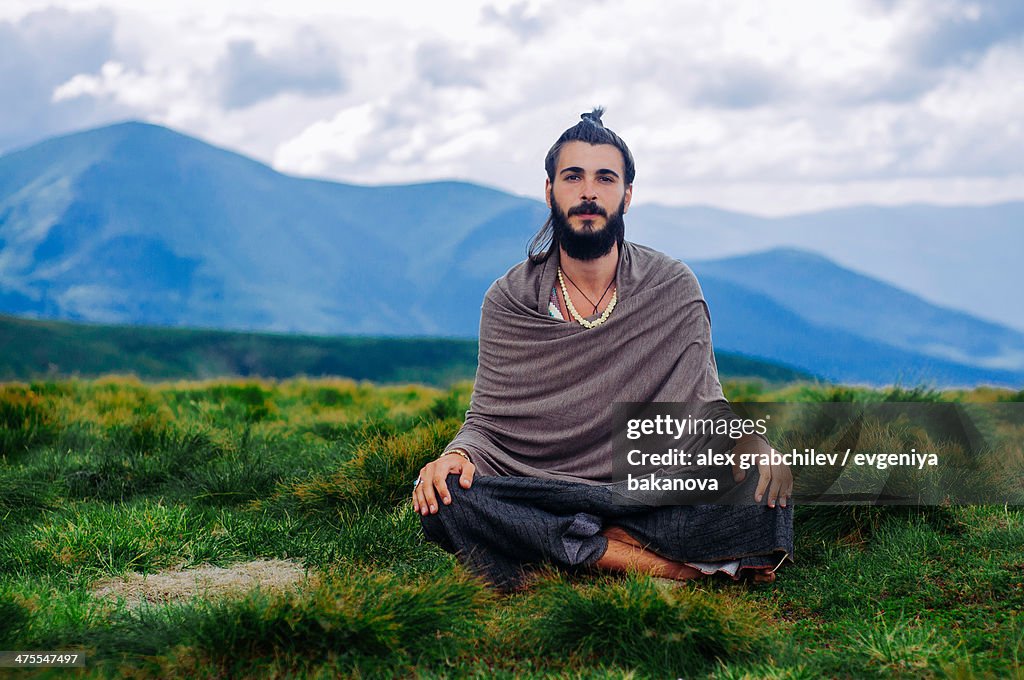 Yogi meditating in mountains, Ukraine