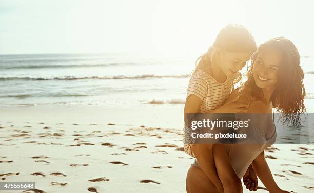 happiness comes in salty water - mother and child in water at beach stock pictures, royalty-free photos & images