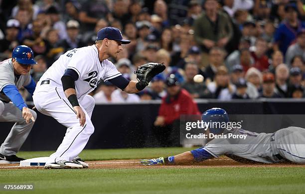 Juan Lagares of the New York Mets slides into third base with a triple ahead of the throw to Will Middlebrooks of the San Diego Padres during the...