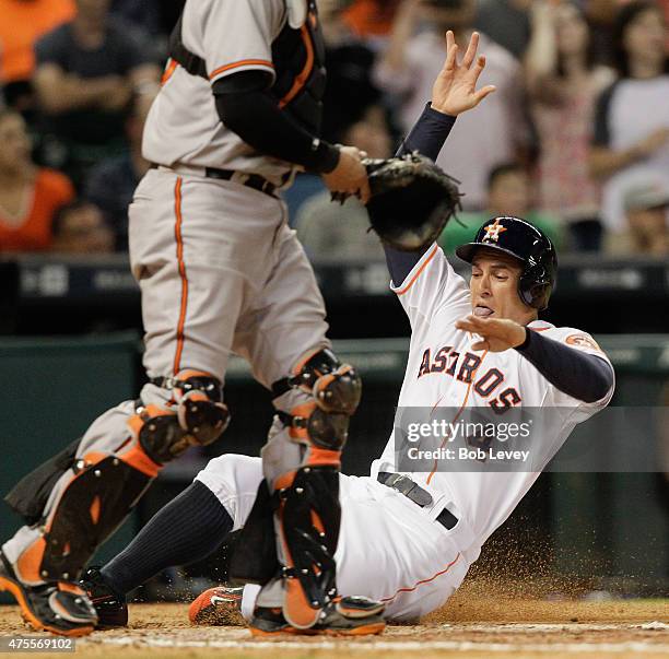 George Springer of the Houston Astros scores on a single by Evan Gattis of the Houston Astros in the seventh inning against the Baltimore Orioles at...
