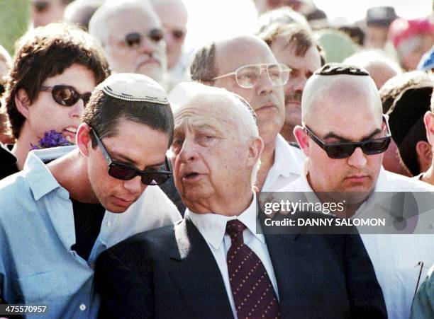 Israeli Prime Minister Ariel Sharon speaks with one of his two sons Gilad during the funerals of Ariel Sharon's wife Lili near Tel Aviv, 29 February...