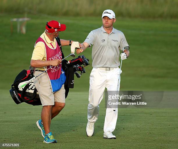 Michael Hoey of Northern Ireland and his caddie celebrate moments after he carded seven straight birdies during the second round of the Tshwane Open...