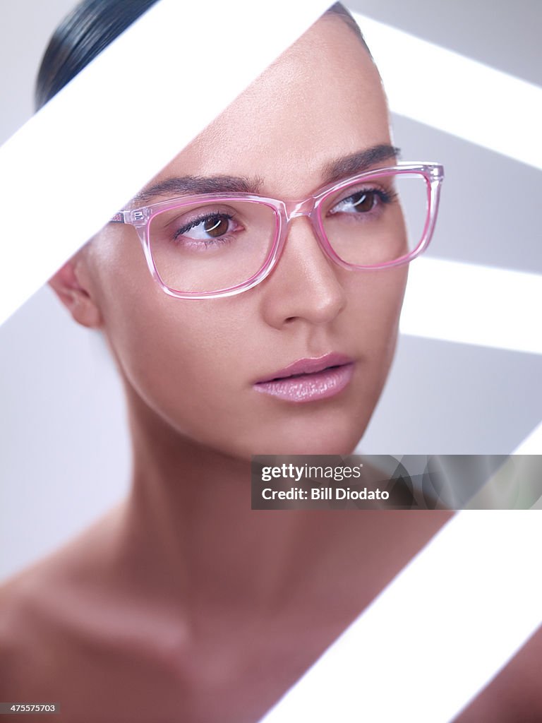 Woman with glasses surround by neon lights