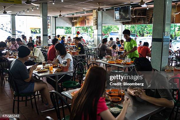 Customers dine at a restaurant in the Pandamaran area of Klang, Selangor, Malaysia, on Wednesday, May 27, 2015. Malaysia's ringgit fell for a sixth...