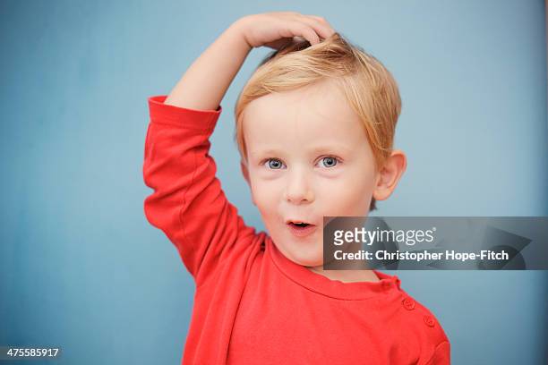 young boy pulling a silly face - children only stock-fotos und bilder