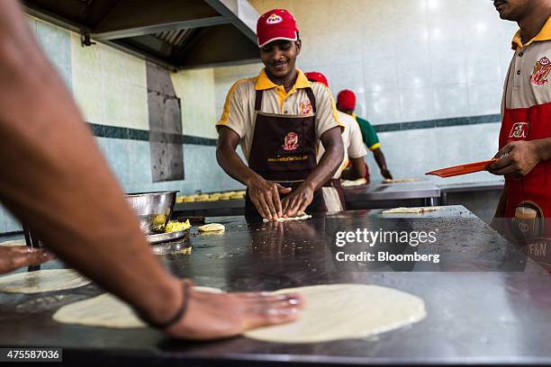 Cooks prepare flatbread, known as roti canai, at a restaurant in the Pandamaran area of Klang, Selangor, Malaysia, on Wednesday, May 27, 2015....