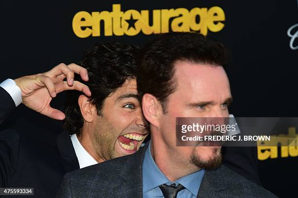 Actor Adrien Grenier photo bombs fellow cast member Kevin Dillon on arrival for the premiere of the film "Entourage" in Los Angeles, California on...