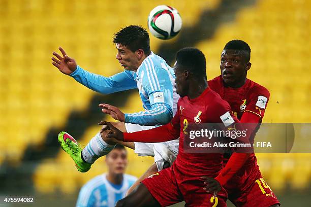 Giovanni Simeone of Argentina jumps for a header with Emmanuel Ntim and Joseph Aidoo of Ghana during the FIFA U-20 World Cup New Zealand 2015 Group B...