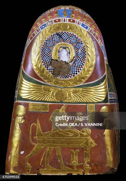 Anubis in the throes of performing the ritual of embalming, decorative detail of a male funeral mask, painted and gilded cartonnage, from Meir....