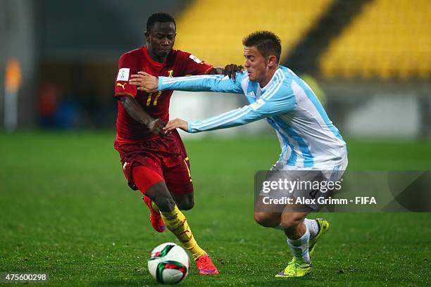 Yaw Yeboah of Ghana is challenged by Nicolas Tripichio of Argentina during the FIFA U-20 World Cup New Zealand 2015 Group B match between Argentina...