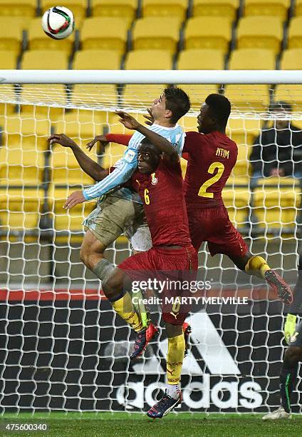 Giovanni Simeone of Argentina jumps for the ball with Emmanuel Ntim and Godfred Donsah of Ghana during their FIFA Under-20 World Cup football match...