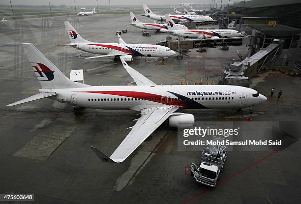 Malaysia Airlines ground staff work on the tarmac outside the Kuala Lumpur International Airport on June 2, 2015 in Sepang, Malaysia. Chief Executive...