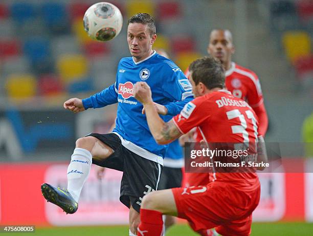 Christian Mueller of Bielefeld kicks the ball before Christian Weber of Duesseldorf during the Second Bundesliga match between Fortuna Duesseldorf...