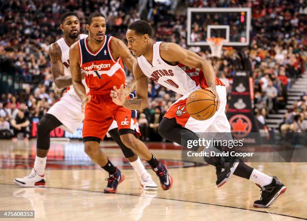 Toronto Raptors shooting guard DeMar DeRozan drives to the basket past Washington Wizards small forward Trevor Ariza during the game between the...