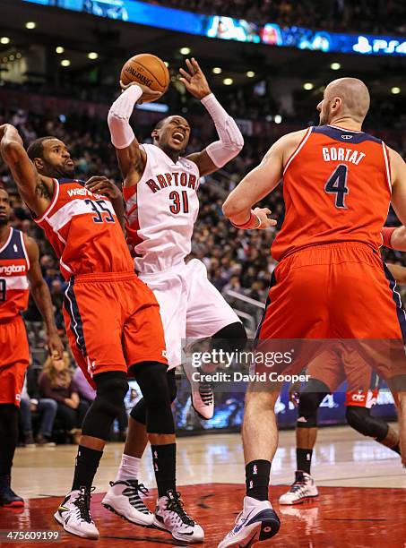 Toronto Raptors small forward Terrence Ross has a painful landing in the paint against Washington Wizards power forward Trevor Booker during the game...