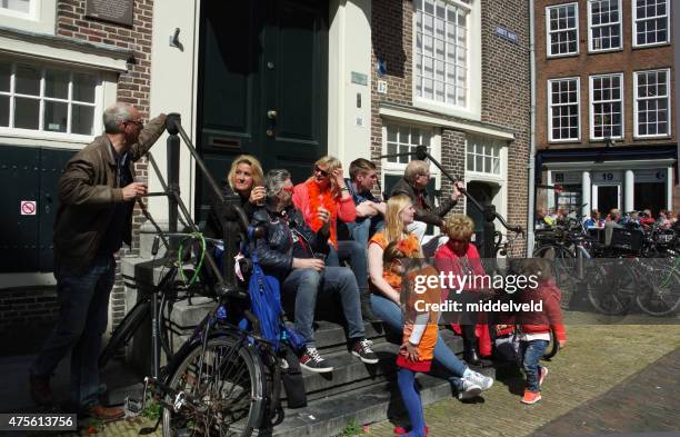 people in the city of haarlem at koningsdag - haarlem stock pictures, royalty-free photos & images