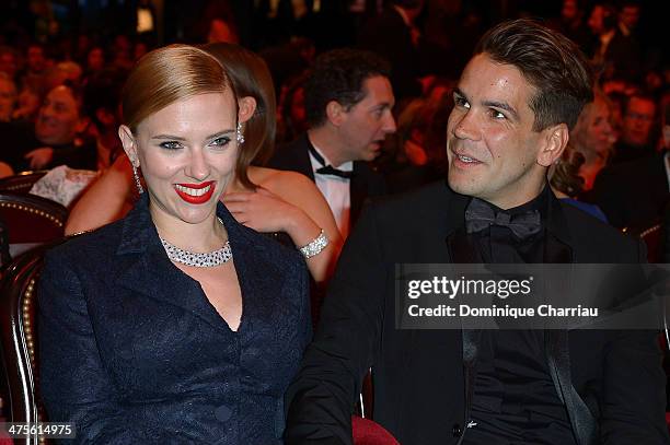 Actress Scarlett Johansson and Romain Dauriac sit in the audience before the start of the 39th Cesar Film Awards 2014 at Theatre du Chatelet on...