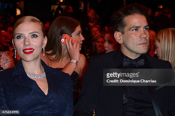 Actress Scarlett Johansson and Romain Dauriac sit in the audience before the start of the 39th Cesar Film Awards 2014 at Theatre du Chatelet on...