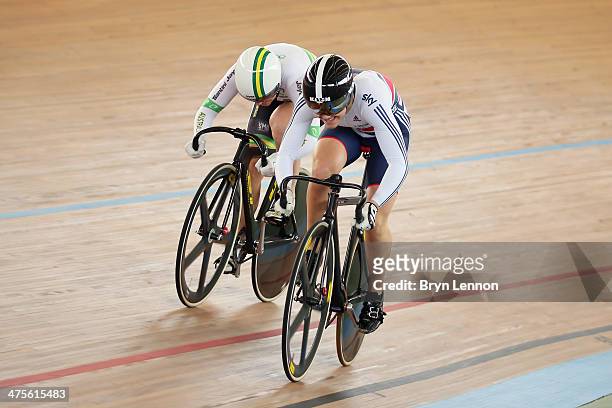 Jessica Varnish of Great Britain rides against Anna Meares of Australia in the 1/8 round of the Women's Sprint during day three of the 2014 UCI Track...