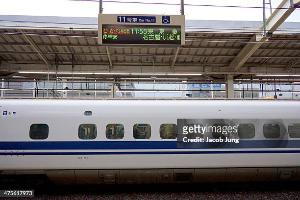 Exterior of an N700 series Shinkansen bullet train stopped at Kyoto Station.