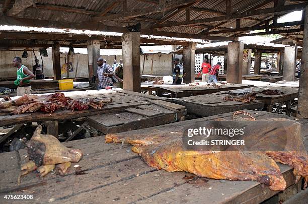 Nigerians stand near the site of a suicide attack at a busy cattle market in the northeastern Nigerian city of Maiduguri on June 2, 2015. At least 13...