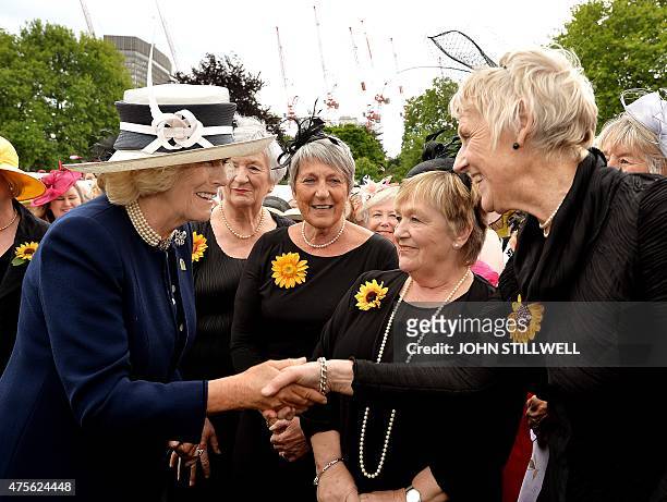 Britain's Camilla, Duchess of Cornwall talks with the Calender Girls, a group of women who posed for a nude calendar to raise funds for Leukaemia...