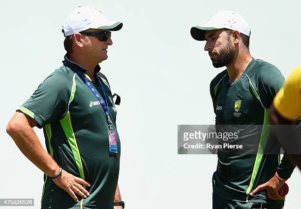 Australian Selector Mark Waugh speaks to Fawad Ahmed of Australia during an Australian nets session at Windsor Park on June 2, 2015 in Roseau,...