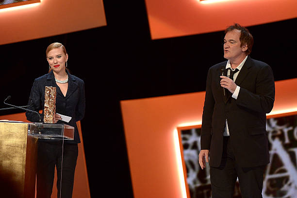 Director Quentin Tarantino hands out the Honorary Cesar to actress Scarlett Johansson on stage during the 39th Cesar Film Awards 2014 at Theatre du...