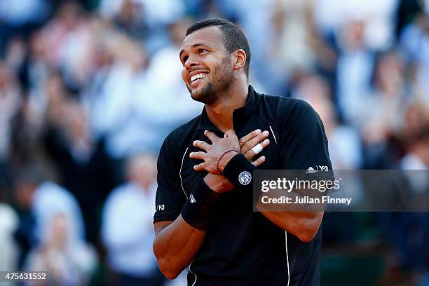 Jo-Wilfried Tsonga of France celebrates winning the match in his Men's quarter final match against Kei Nishikori of Japan on day of the 2015 French...