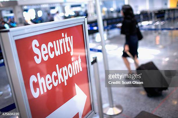 Sign directs travelers to a security checkpoint staffed by Transportation Security Administration workers at O'Hare Airport on June 2, 2015 in...