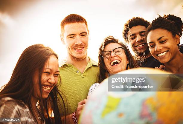 teenagers college student smiling with globe - international student stockfoto's en -beelden