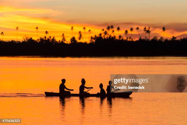 family canoeing silhouette at sunrise solomon islands malaita - solomon islands stock pictures, royalty-free photos & images