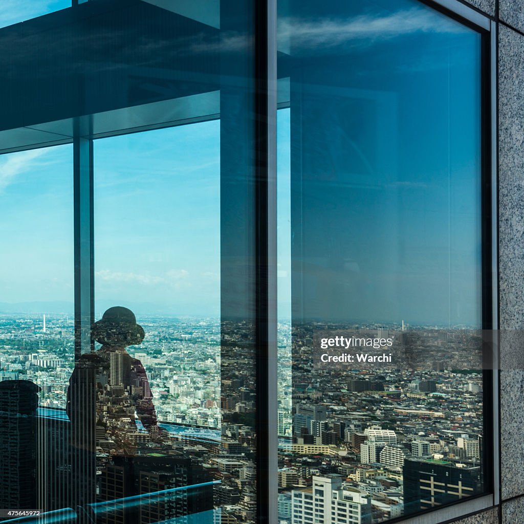 Japanese woman in Tokyo looking at the city