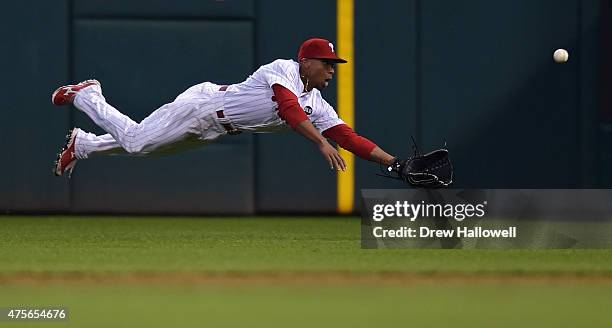 Ben Revere of the Philadelphia Phillies dives for the ball but is unable to make the catch in third inning against the Cincinnati Reds at Citizens...