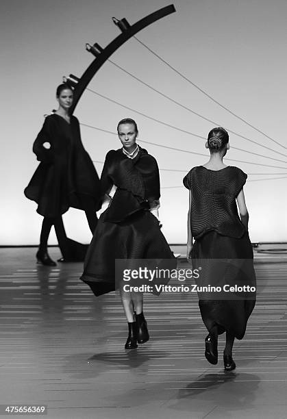 Models walk the runway during the Issey Miyake show as part of the Paris Fashion Week Womenswear Fall/Winter 2014-2015 at Espace Vendome on February...