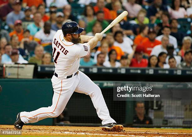 Evan Gattis of the Houston Astros connects on a three-run home run in the third inning during their game against the Baltimore Orioles at Minute Maid...